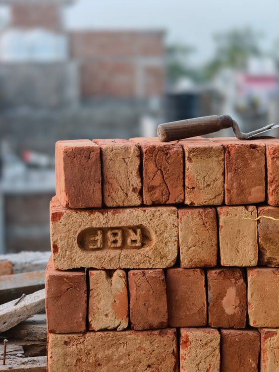 Stacked bricks with a masonry trowel